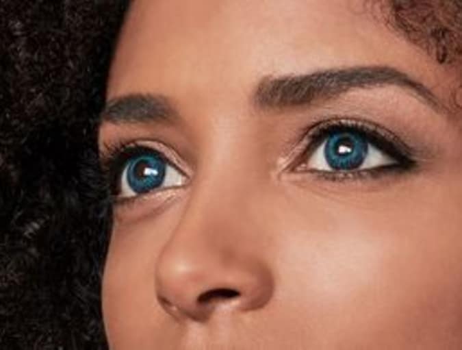 Woman with brown eyes wearing blue coloured contact lenses
