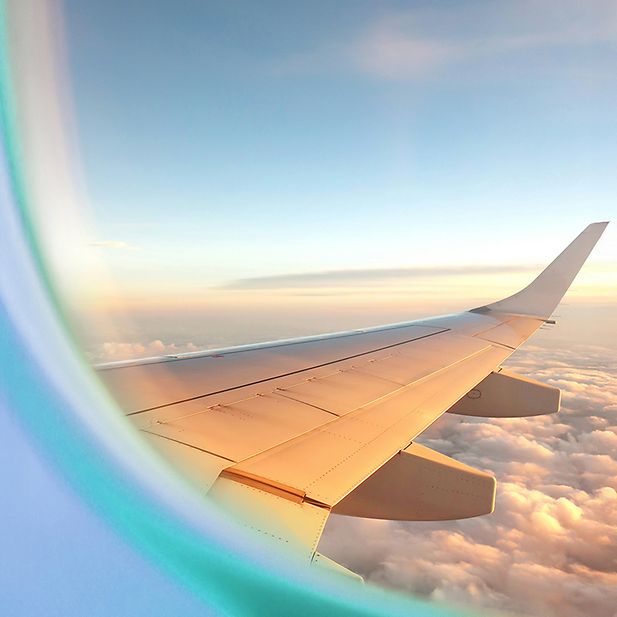 Airplane in a clear blue sky with clouds
